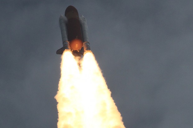 Condensation forms ahead of the Space Shuttle Atlantis solid rocket boosters as they approach the speed of sound