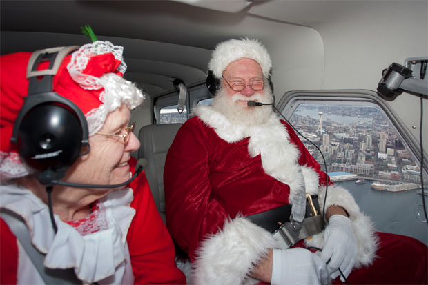 Santa and Mrs Claus fly past the Seattle Space Needle